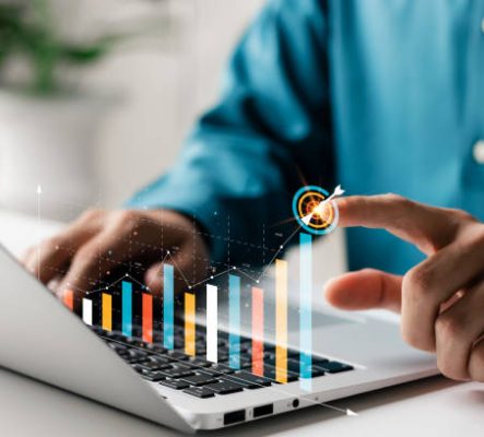 istockphoto-1418476287-612×612 Businessman analyzing company's financial balance sheet working with digital augmented reality graphics. Businessman calculates financial data for long-term investment.
